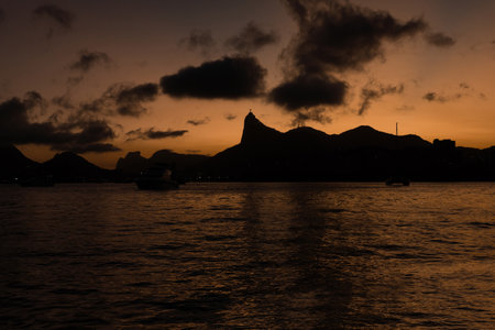Sunset in the bay of Guanabara, cove and beaches of Rio de Janeiro, Brazil with its buildings, boats...