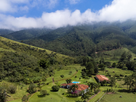 Aerial view of beautiful forest full of nature and pasture fields in TremembÃ© in Vale da ParaÃ­ba in SÃ£o Paulo. Mountains and hills in sunny day. Lots of green and tropical vegetation. Drone.の写真素材