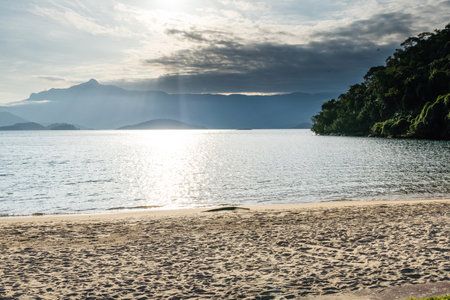 Beautiful beach in Angra do Reis, green coast of Rio de Janeiro. Tangua Beach. Hills and mountains in the background on a sunny day. Crystal clear water. Late afternoon.の写真素材
