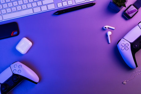 Office desk with Next Generation white game controller, watch, ssd storage, earphone and keyboard....