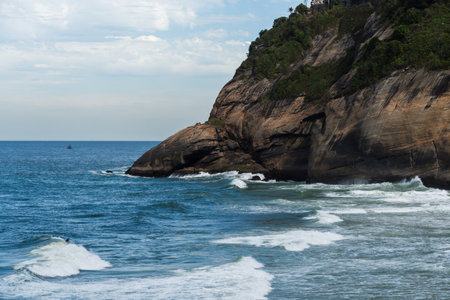 Joatinga Beach, a paradise in Rio de Janeiro, Brazil. Sunny day in the morning. Emerald green sea with good waves for surfers. Mountains and hills around and a lot of nature.の写真素材