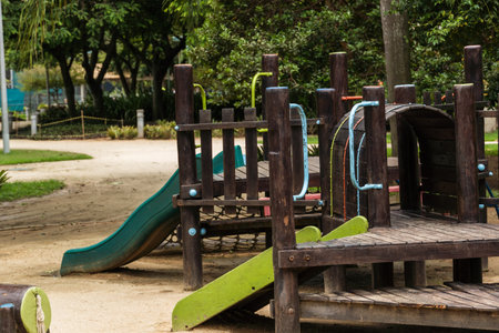Tunnel and slider, rustic and colorful playground for children in the park, children's corner....