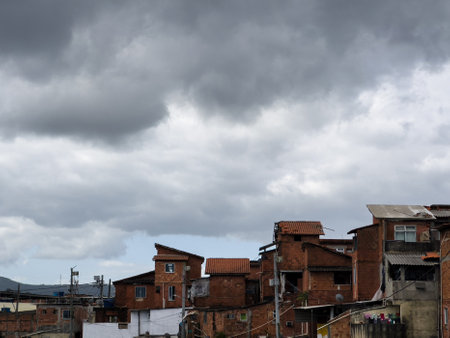 Favela Cidade de Deus in Rio de Janeiro, Brazil. Open sewer, with a lot of pollution and dirt. Wooden and brick houses on the edge. Poverty situation in South America. Shanty town. Slum.の写真素材