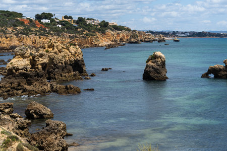 Rocky seashore. View of Praia da Vigia and Praia dos Arrifes beach in Albufeira, Algarve, Portugal, Europe.の写真素材