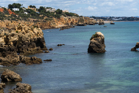 Rocky seashore. View of Praia da Vigia and Praia dos Arrifes beach in Albufeira, Algarve, Portugal, Europe.の写真素材