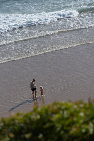 Father and little daughter playing at Praia do Beliche beach in Sagres, Algarve, Portugal. Sunny day at sunset. Family.の写真素材