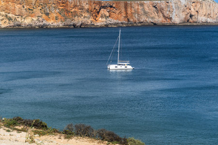 Rocky coastline in Sagres, on the Algarve coast of Portugal. Cabo de SÃ£o Vincente Lighthouse.の写真素材