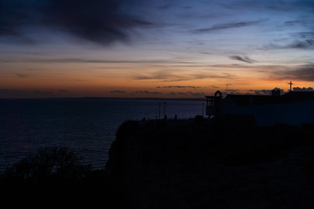 Algar Seco in Carvoeiro. Beautiful Golden Sandstone Rock Formation in Algarve with Atlantic Ocean in the Distance. Rocks, rocky shore, yellow rocks, coquina, beautiful coastline. Sunset.の写真素材
