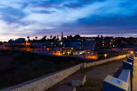 Algar Seco in Carvoeiro. Beautiful Golden Sandstone Rock Formation in Algarve with Atlantic Ocean in the Distance. Rocks, rocky shore, yellow rocks, coquina, beautiful coastline. Sunset.の写真素材