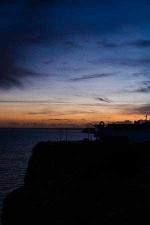 Algar Seco in Carvoeiro. Beautiful Golden Sandstone Rock Formation in Algarve with Atlantic Ocean in the Distance. Rocks, rocky shore, yellow rocks, coquina, beautiful coastline. Sunset.の写真素材
