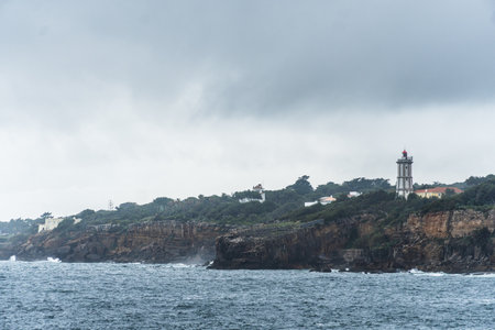 Boca do Inferno (Hell's Mouth) is a unique rock formation on the edge of the ocean in Cascais, Portugal. Cloudy day. Dramatic sea and skyの写真素材