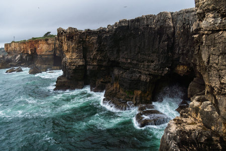 Boca do Inferno (Hell's Mouth) is a unique rock formation on the edge of the ocean in Cascais, Portugal. Cloudy dayの写真素材