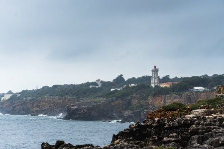 Boca do Inferno (Hell's Mouth) is a unique rock formation on the edge of the ocean in Cascais, Portugal. Cloudy day. Dramatic sea and skyの写真素材