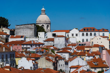 View of the beautiful skyline of Lisbon, Portugal, with red roofed, colorful houses in the Alfama district during a sunny day.の写真素材