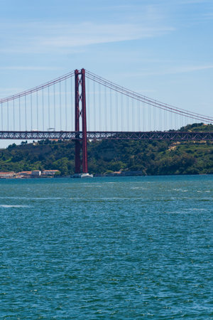 The 25th April Bridge, Ponte 25 de Abril in Portuguese, the longest suspension bridge in Europe. Connecting the city of Lisbon, capital of Portugal, to the municipality of Almada over the Tagus Riverの写真素材