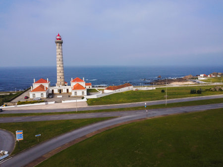 View of Portuguese lighthouse, with nice details and very particular framing, blue sky as background, located in LeÃ§a da Palmeira, Porto, Portugal. Matosinhos. LeÃ§a Beach. Drone. Aerial view.の写真素材