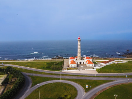 View of Portuguese lighthouse, with nice details and very particular framing, blue sky as background, located in LeÃ§a da Palmeira, Porto, Portugal. Matosinhos. LeÃ§a Beach. Drone. Aerial view.の写真素材
