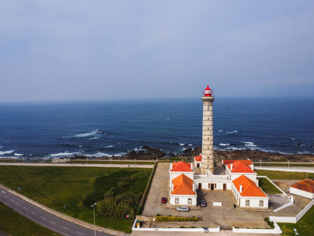 View of Portuguese lighthouse, with nice details and very particular framing, blue sky as background, located in LeÃ§a da Palmeira, Porto, Portugal. Matosinhos. LeÃ§a Beach. Drone. Aerial view.の写真素材