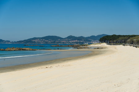 View of Playa de Samil, the main beach of Vigo in Galicia in northwest Spain. Sunny day, crystal clear blue sea.の写真素材