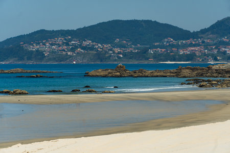 View of Playa de Samil, the main beach of Vigo in Galicia in northwest Spain. Sunny day, crystal clear blue sea.の写真素材