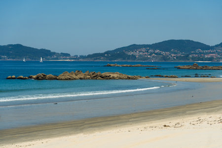 View of Playa de Samil, the main beach of Vigo in Galicia in northwest Spain. Sunny day, crystal clear blue sea.の写真素材