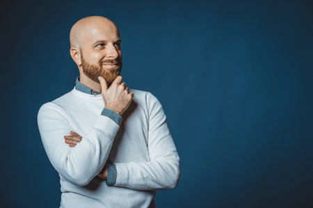 Photo of a caucasian nice guy with beard and blue backgroundの写真素材