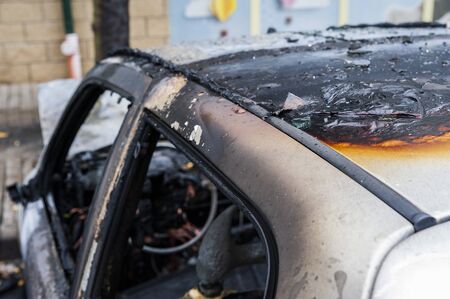 Closeup of the car burnt down on the city car parkの写真素材