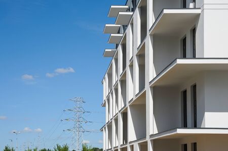 Modern building under construction. White walls and blue sky