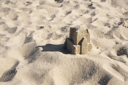 Closeup of the little sandcastle on the beachの写真素材