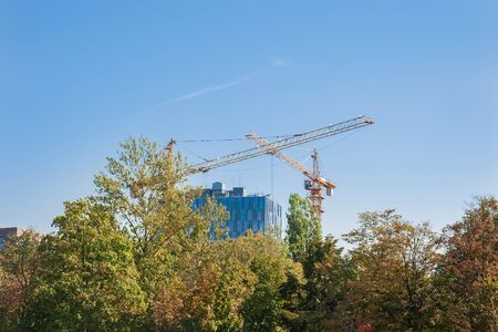 Construction site of modern building with glass facade in the parkの写真素材