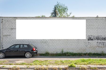 Blank white advertising banner on the old brick wallの写真素材