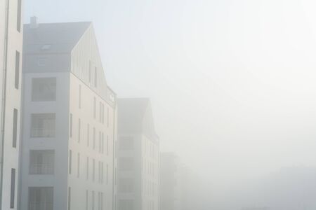 Modern apartment buildings in a foggy morningの写真素材
