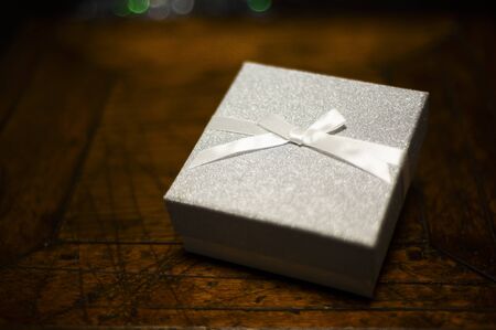 Little gift box on the dark wooden table