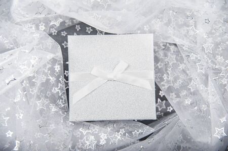 Abstract christmas background. Gift box and starry tablecloth.