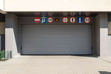 Underground garage gate in the modern residential building on sunny summer dayの写真素材