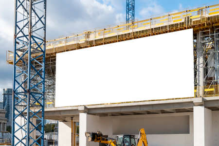 Blank white advertising billboard on the fence of construction site in downtownの写真素材