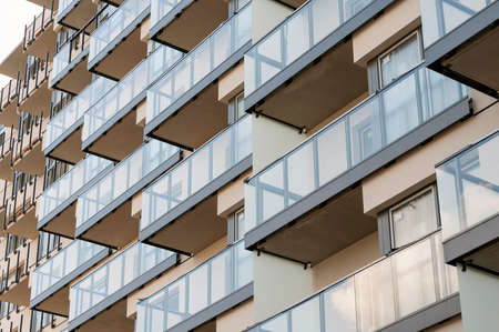 Construction site of modern residential building with glass balcony railingsの写真素材