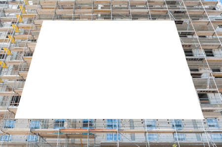 Blank white afvertising banner mounted on the scaffoldings