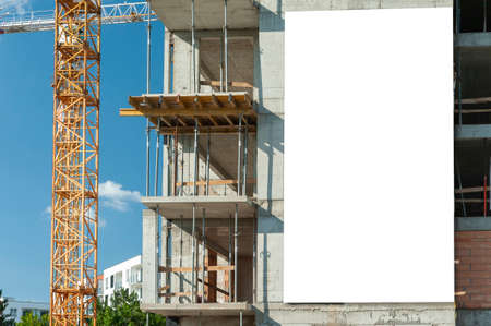 Advertising banner mock-up on the wall of building under constructionの写真素材