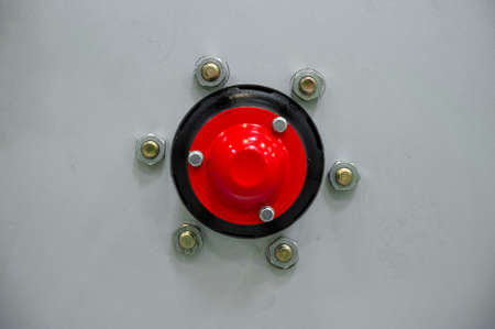 Close-up of industiral machine rim with screws and red hub
