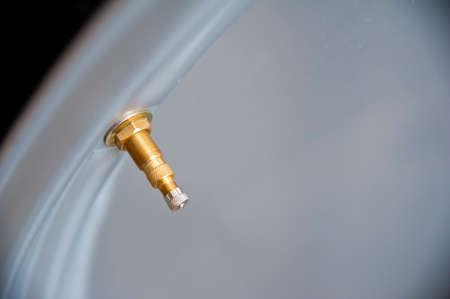 Close-up of wheel valve and gray rimの写真素材