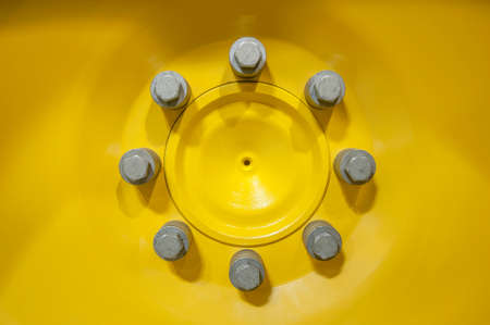 Close-up of yellow wheel rim with screwsの写真素材