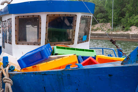 Colorful fish crates on the board of fishing boatの写真素材