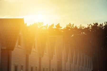 Row of wooden holiday houses at sunsetの写真素材