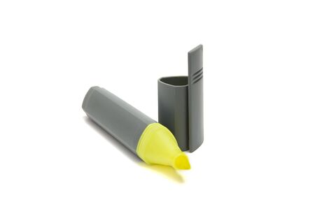 Yellow highlighter pen with cap beside it isolated on whiteの写真素材