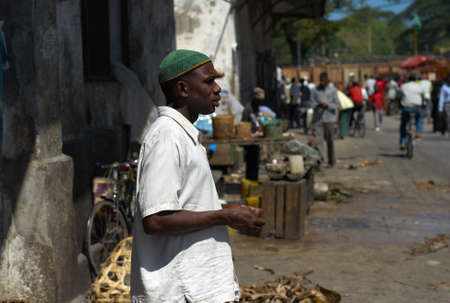 STONE TOWN, ZANZIBAR, TANZANIA - JULY 06 2008: A local man waiting behind the fish market in Stone...