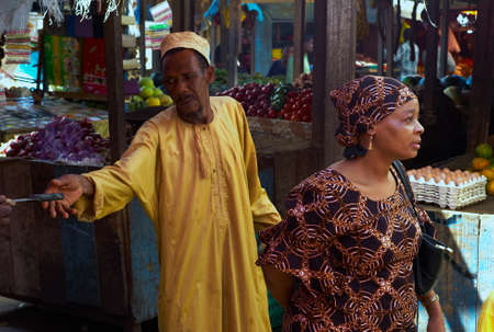 STONE TOWN, ZANZIBAR, TANZANIA - JULY 06 2008: A Man reaching for a knife.のeditorial素材