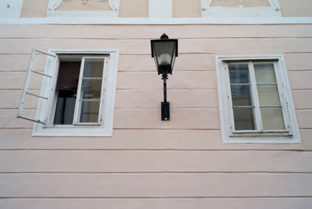 A Pink Wall with Old Windows and a Lantern