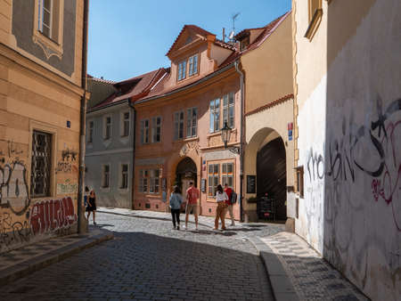 Prague, Czech Republic - June 8 2019: Lesser Town of Prague Street Scene with Tourists and Old Buildings, Tri Stoleti Cafe and Restaurant and Cobblestonesのeditorial素材