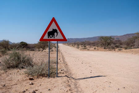 Elephant Crossing Road Warning Sign in Namibia, Triangle Shape, Danger of Animal Collisions Attention Signの写真素材